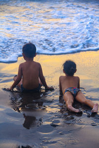 Girl and a boy spending time together at love beach bali indonesia