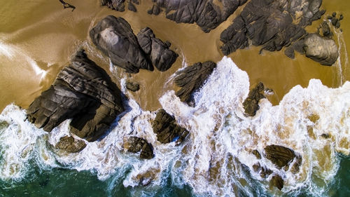 Aerial view of rock formations on shore