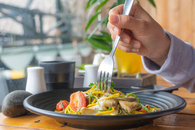 Midsection of person preparing food in restaurant