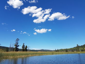 Scenic view of lake against blue sky