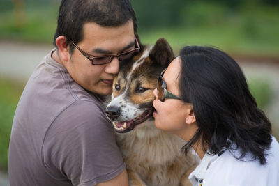 Rear view of couple with dog