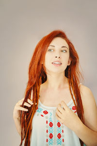 Portrait of a smiling young woman against white background