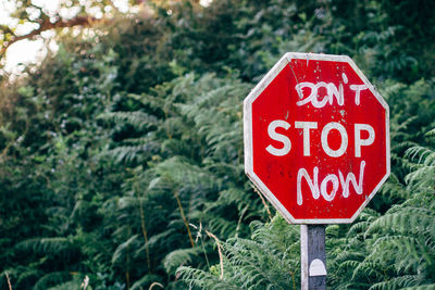 Stop sign against trees