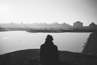 Rear view of silhouette woman standing against clear sky