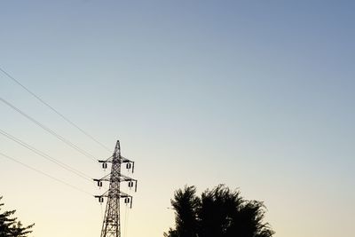 Low angle view of power lines against clear sky