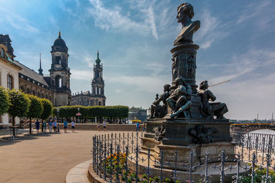 Statue of historic building against cloudy sky