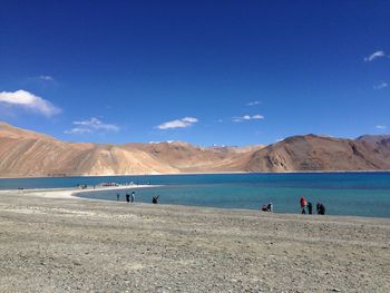 Scenic view of desert against blue sky