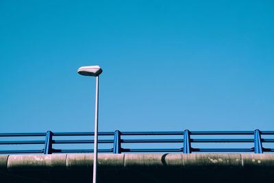 Low angle view of street light against clear blue sky