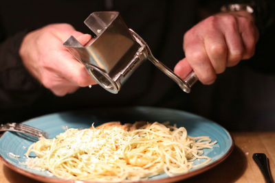 Midsection of man preparing food