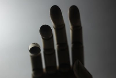Close-up of artificial hand over gray background