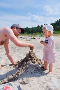 Full length of siblings on beach