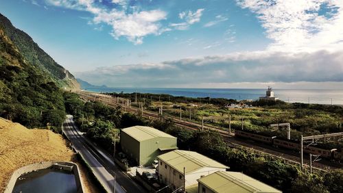 High angle view of buildings by sea against sky