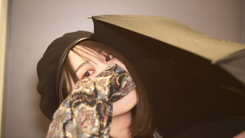 Portrait of young woman wearing hat