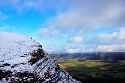 Scenic view of mountains against cloudy sky