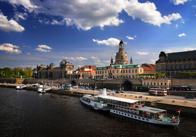 Boats in river with buildings in background