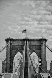 Low angle view of arch bridge against cloudy sky