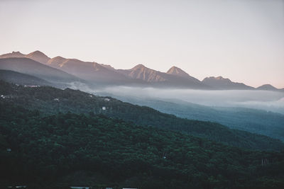 Scenic view of mountains against clear sky during sunset