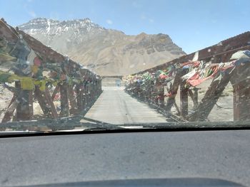 Road leading towards mountains against sky