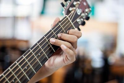 Close-up of hand playing guitar