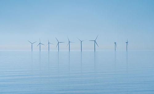 Offshore wind turbines generating renewable electricity and energy  background image
