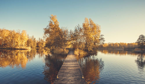 Scenic view of lake against clear sky during autumn