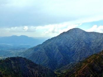 Scenic view of mountains against cloudy sky