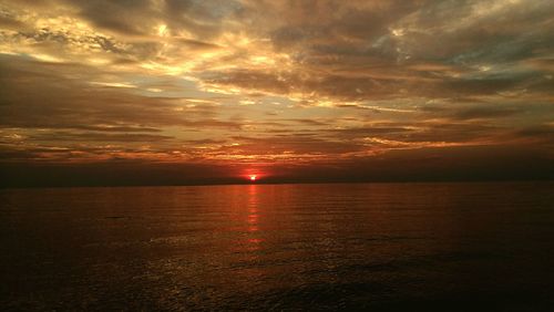 Scenic view of sea against sky at sunset