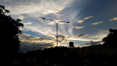 Low angle view of street lights against sky