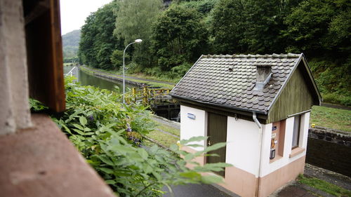 House amidst trees and plants outside building