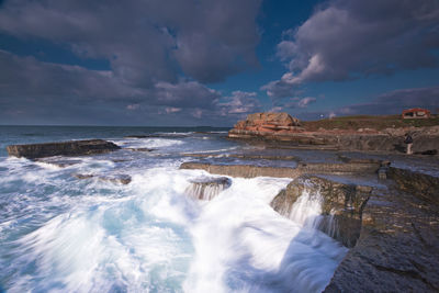 Scenic view of sea against cloudy sky