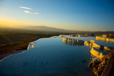 Scenic view of lake against sky during sunset