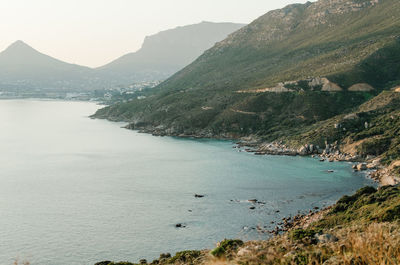 Scenic view of sea and mountains against sky
