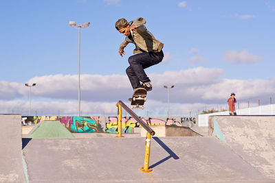 Full length of man skateboarding on railing