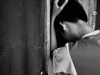 Close-up of boy leaning on wall