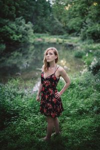 Young woman standing in forest