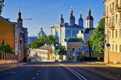 Street amidst buildings against sky in city