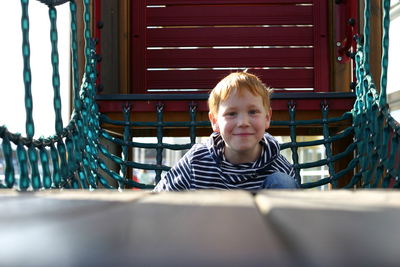 Portrait of boy on playground equipment