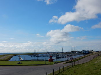 Scenic view of harbor against blue sky