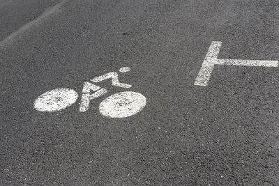 High angle view of arrow symbol on road