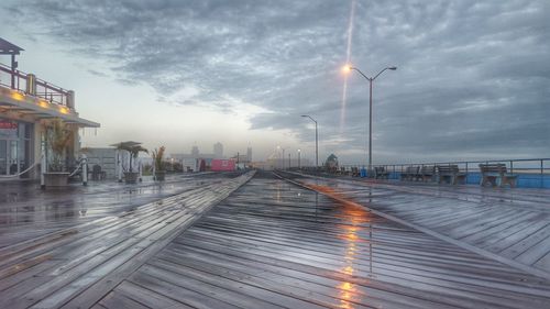 Street light against cloudy sky