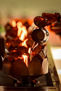 Close-up of burning candles on barbecue grill