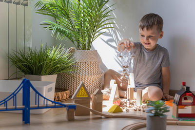 Portrait of cute girl sitting on table at home