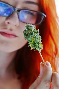 Close-up of young woman holding marijuana