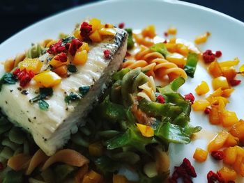 Close-up of fish with pasta in plate