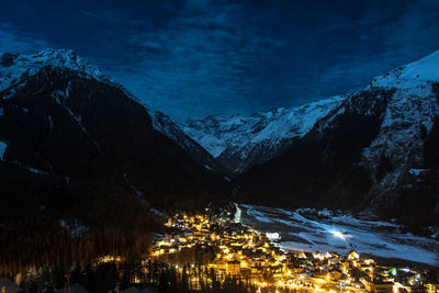 Illuminated city against sky at night during winter