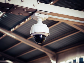 Low angle view of security camera in train station