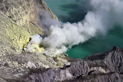 High angle view of mountains amidst smoke