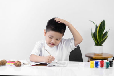 Portrait of boy looking at table