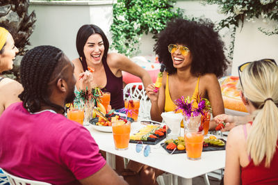 Cheerful friends during social gathering