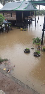 High angle view of wet footpath by buildings in city